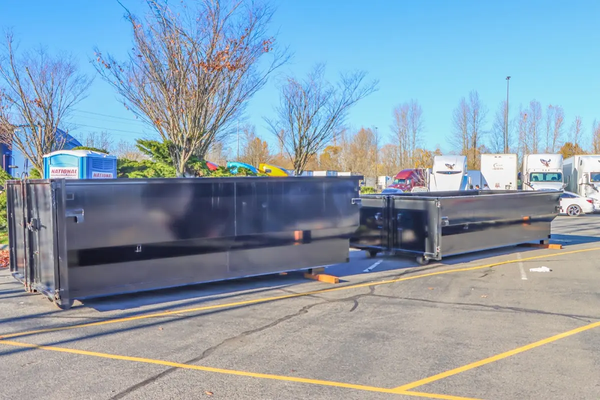 Professional dumpster rental service with roll-off container on residential driveway in Nipomo